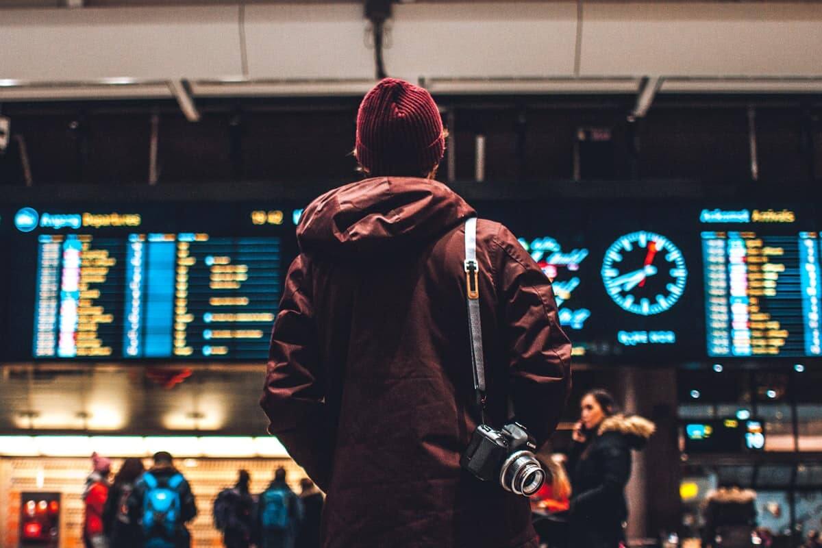 Traveler checking the departures board before a flight