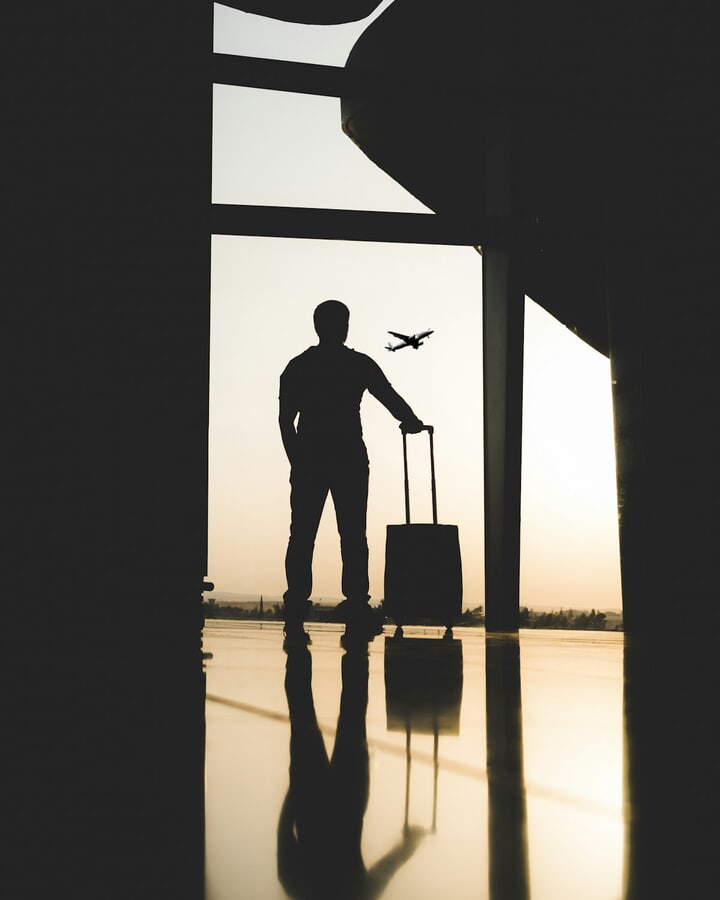 Traveler with luggage inside an airport terminal