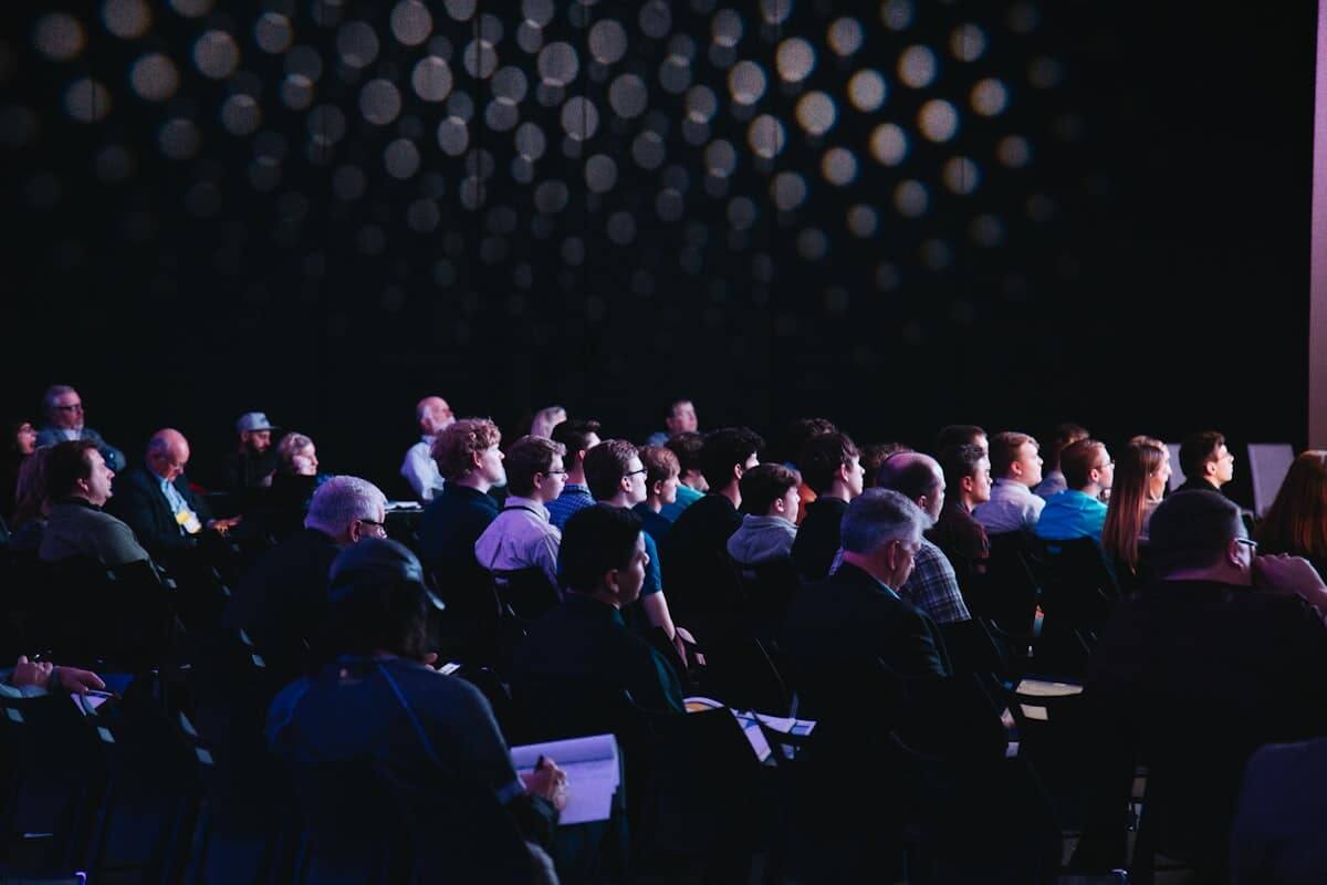 Conference attendees seated for a session at a convention center