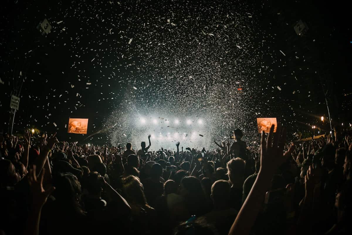 Festival crowd on an outdoor field at golden hour