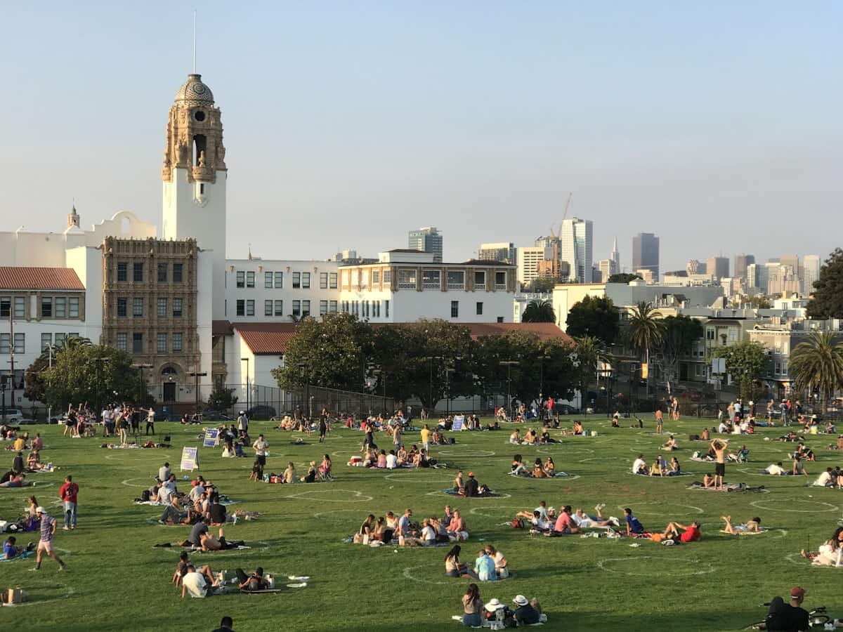 Crowd gathered on a sunny San Francisco park lawn, the scene on 4/20