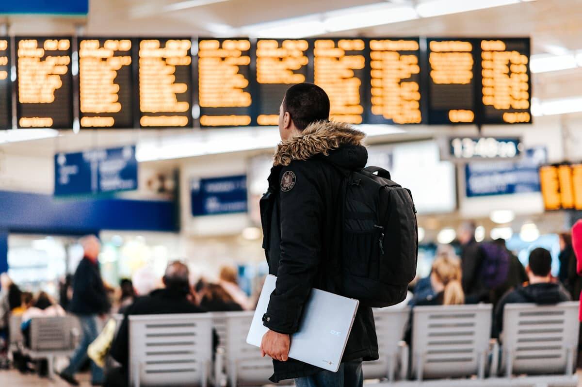 Traveler checking flight times — build buffer into any SFO layover plan